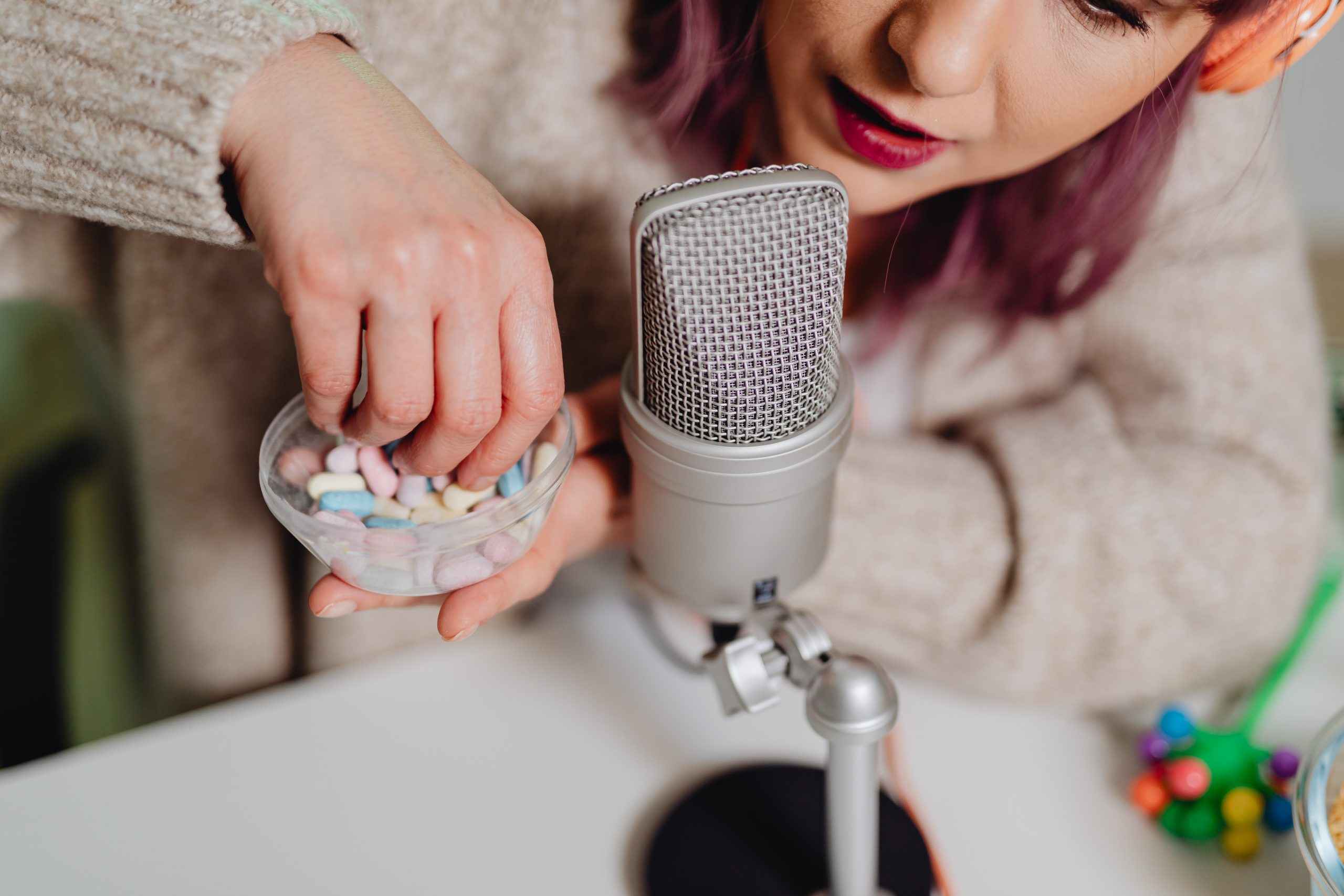 best content for youtube channels - Image of a woman playing with candy next to a microphone